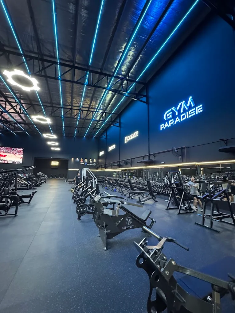 Main training floor with neon GYM PARADISE sign